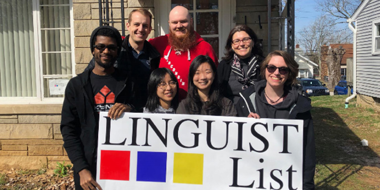 Students hold up a sign for "Linguist List"
