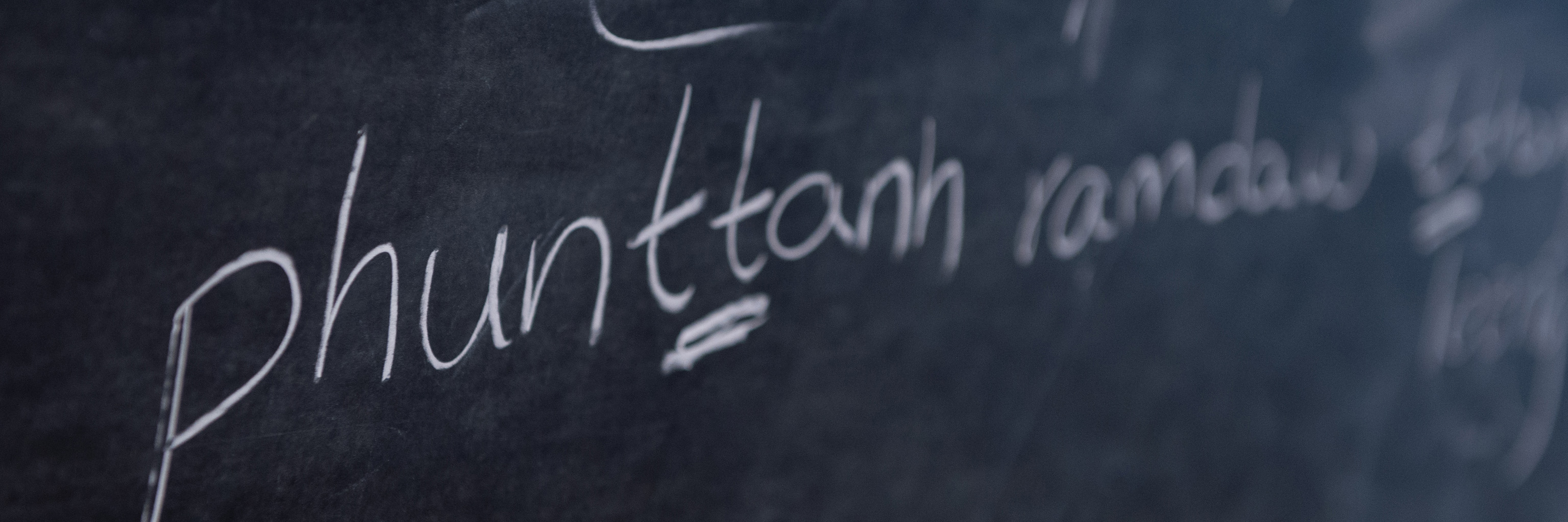 Close up of a linguistics lesson on a chalkboard. 