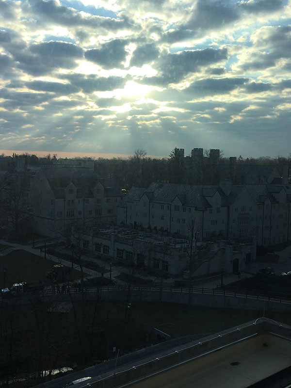 The sun shines through clouds, overlooking IU Bloomington's campus.