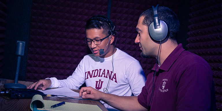 A faculty member and a student using audio lab equipment.