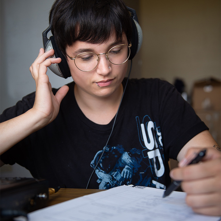 A grad student using audio lab equipment.